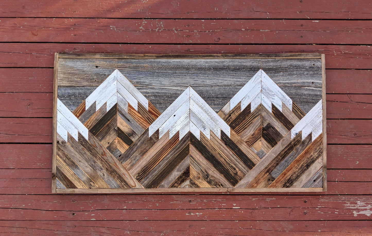 Rustic mountain wood wall art with gray sky.